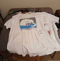 Stack of T-shirts on hangers, front shirt San Francisco Fog graphic