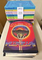 Stack showing DeadBase XV and other DeadBase volumes with The Other Side of the Grateful Dead cover