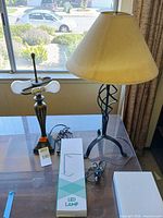 Overview showing two metal table lamps, beige shade, boxed LED lamp
