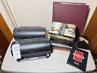 Overall lot showing two DVD organizers, binder, stack of DVD cases