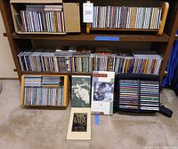 Full bookshelf view showing hundreds of CDs, boxed sets, cassette tapes and CD wallet