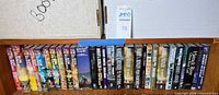Shelf holding L. Ron Hubbard Mission Earth series, Battlefield Earth, and multiple Robert A. Heinlein hardcovers
