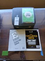 Typewriter case with two pads of typewriter paper on top