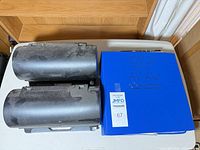 Two dust-covered rotating disc organizers beside blue binder