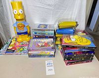 Overall view of Bart container, DVD season sets 1-20, and stacks of Simpsons books/comics