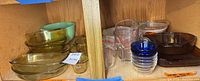 Overall view of assorted glass bakeware in cabinet