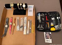Overview showing watches, packaged bands, and repair kit