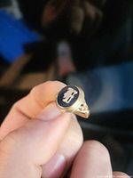 Front view of gold signet ring showing onyx cameo motif