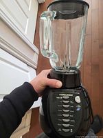 Overall view of blender assembled showing motor base, glass jar, and lid