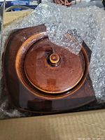 Ceramic fire pot with lid wrapped in bubble wrap inside box