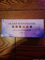 Front of boxed set labeled Plant Scented Oil Space Sweet Atmosphere Set of 6