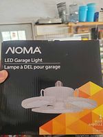 Front of box showing NOMA LED Garage Light imagery
