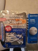 Package of Pride Performance tees and TaylorMade golf ball sleeve front view