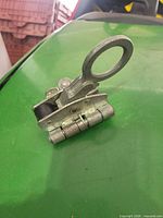 Side profile showing clamp body, ring attachment, black roller cam