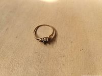 Full view of vintage gold ring on flat surface showing overall design