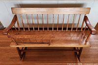 Top view of wooden rocking bench showing spindle back and cradle panel installed