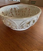 Side view showing exterior fleur-de-lis cut-outs and glaze