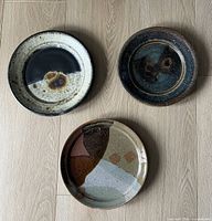 Overview of all three ceramic plates showing size relation and glaze variations