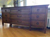 Full view of dresser front and side showing nine-drawer layout, legs and hardware