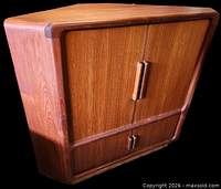 Front view of closed teak corner cabinet showing tambour doors and overall shape