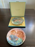 Two Hibel plates, one displayed, one in box