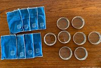 All eight coasters and eight felt pouches displayed