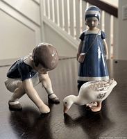 Group view of boy, goose, and Else figurines