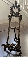 Front view of ornate brass easel stand