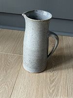 Front view of speckled stoneware jug