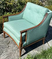 Front three-quarter view of walnut armchair with turquoise upholstery