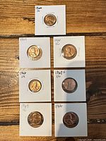 All seven coins in holders on table