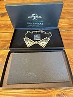 Necklace in open branded box with lid removed