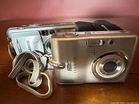 Front and side view of both cameras showing lenses, bodies, and straps