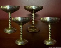 Four of the brass pedestal goblets showing size and patina