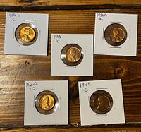 obverse view of five wheat cents in holders