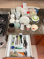 countertop view showing glass bowls, ceramic ramekins, manual pull chopper, fabric bags