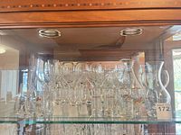 Barware set displayed in cabinet showing quantity and types