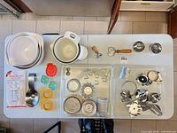 Overview showing mixing bowls, cutters, molds, pastry wheel, scoop, decorating set