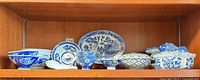 Shelf view showing all blue and white porcelain pieces