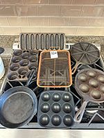 Group shot of seven cookware pieces on stovetop