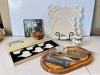 All items grouped: board with utensils, picks, markers, bowls, plates, condiment jar