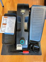 Top view of Cubii Jr elliptical on mat with manual