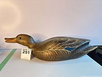 left side profile of the carved wood duck decoy showing overall form and finish