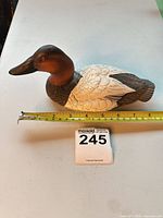 Left side view of decoy with measuring tape showing approximately 9 inches length