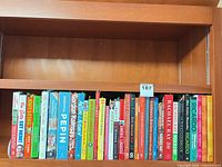 Shelf view showing majority of cookbooks with spines visible