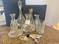 Group shot of all glass decanters, carafes, mixing pitcher and bar tools