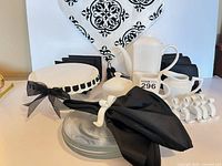 Group shot showing all ceramic pieces, glass plates, napkin rings, napkins, and runner