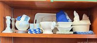 Shelf view showing all ceramic pieces, napkins and apron