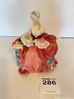 Full view of Royal Doulton Penelope figurine on cushion