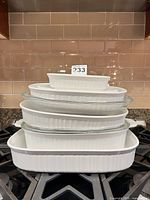 Stacked view of all six dishes with two glass lids and one plastic lid
